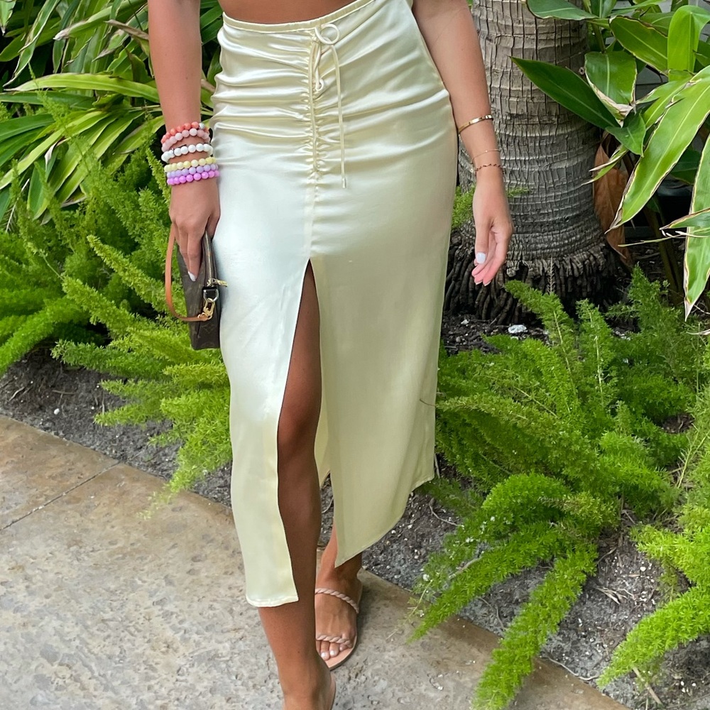 Yellow satin skirt with slit